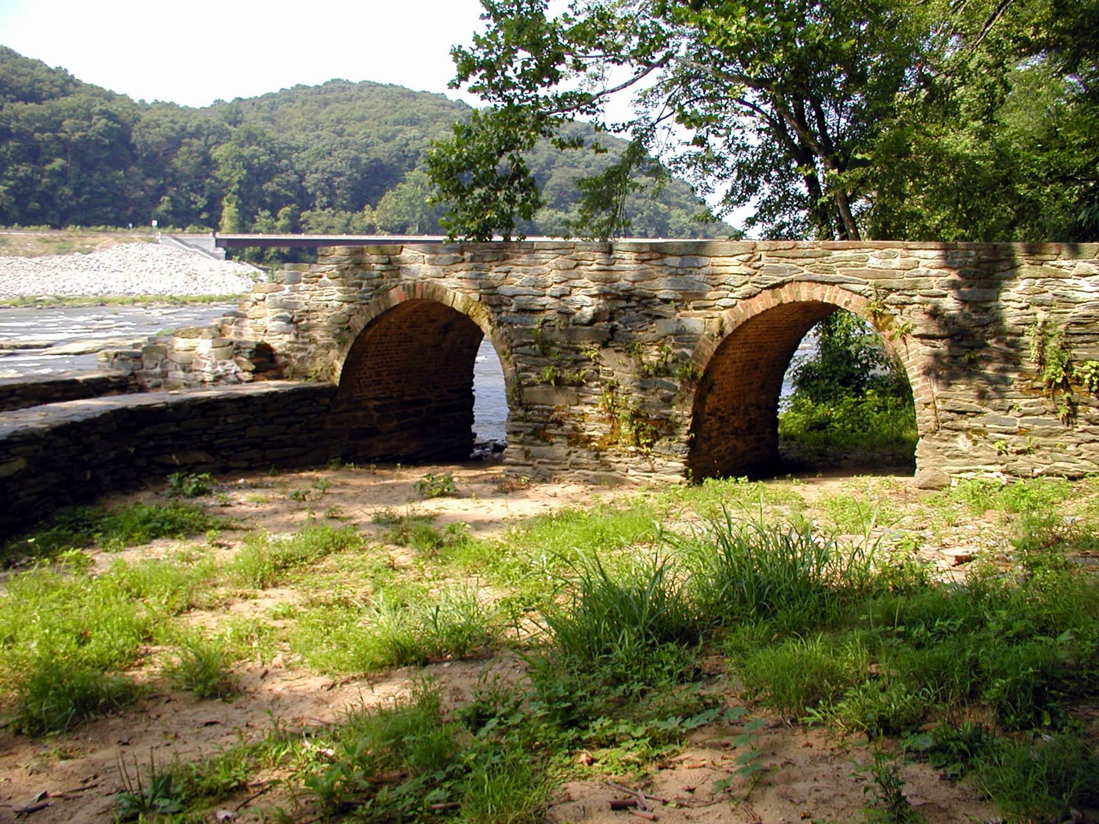Historic stone arches beside the river in Harpers Ferry National Historical Park