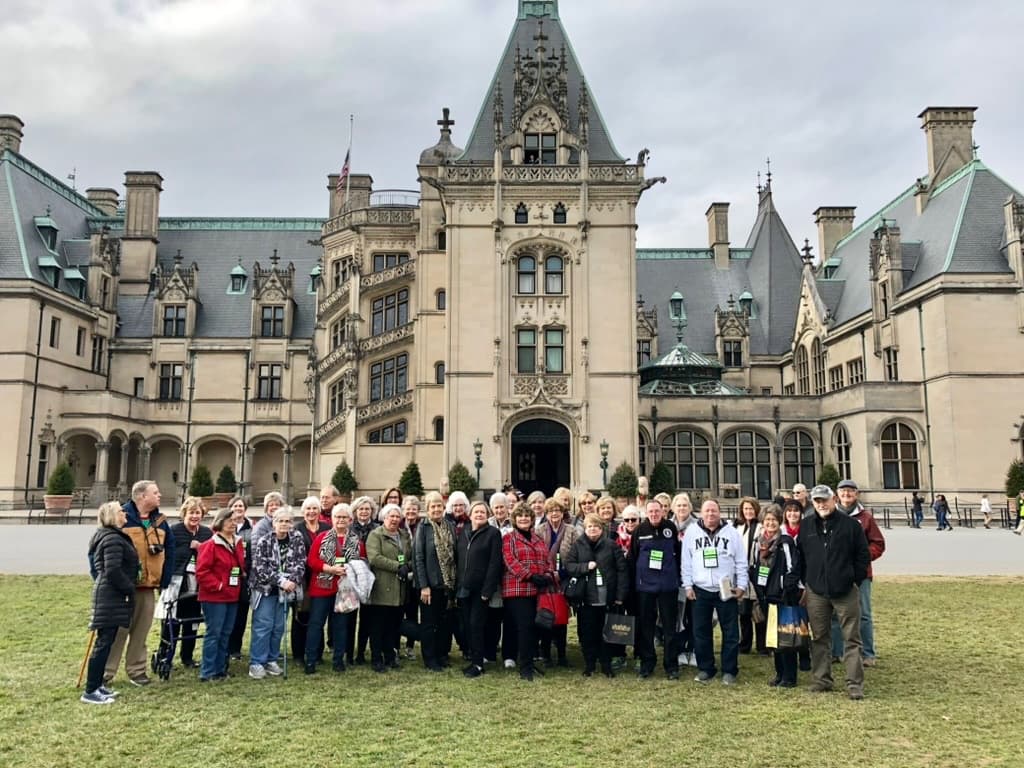 A Great Falls Travel group gathered in front of Biltmore House