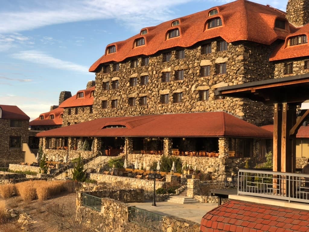 The stone facade and red-tile roof of the Omni Grove Park Inn at golden hour